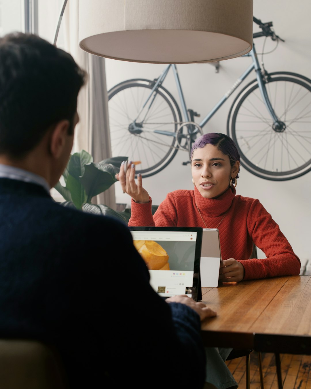 person-in-red-sweater-sitting-at-a-table-p1r-11mrttm